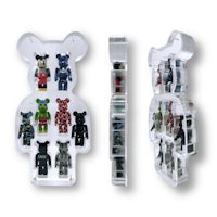 a clear display case with a bearbrick figure in it